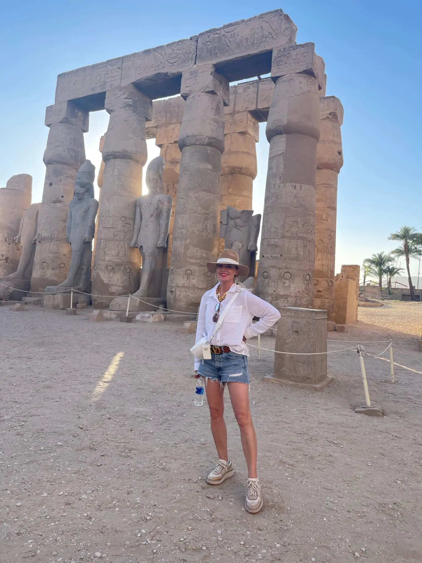 how to dress in middle east, womens dress code in middle east, middle eastern dress female, how to blend in in the middle east, shoes to wear in middle east, what to wear in middle east, how to look stylish in middle east, erin busbee, busbee style, white rails cotton ellis top, hariatt isles hat, moussy vintage packard shorts, paco rabbane chunky neckalce, prada white raffia bag, chloe platform sneakers, luxor, egypt