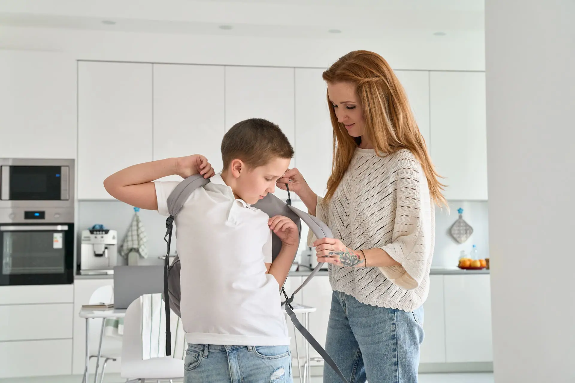 mom helping child with backpack, Back-to-school anxiety, kids anxiety, back-to-school worries, help kids anxiety, child worried about school, kid worried about school, help kid feel better about school