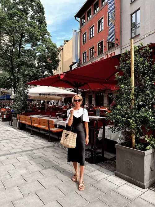 Black silk slip dress in midi length by Quince paired with Prada raffia and leather tote, white tee and frankie4 beige and gold sandals