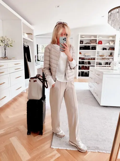 layered comfy travel outfit featuring softstream white lululemon pants, veronica beard valentina sneakers, Herno 3/4 sleeve mockneck puffer and an open knit white hoodie sweater from Ann Taylor