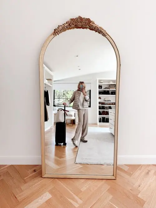 layered comfy travel outfit featuring softstream white lululemon pants, veronica beard valentina sneakers, Herno 3/4 sleeve mockneck puffer and an open knit white hoodie sweater from Ann Taylor