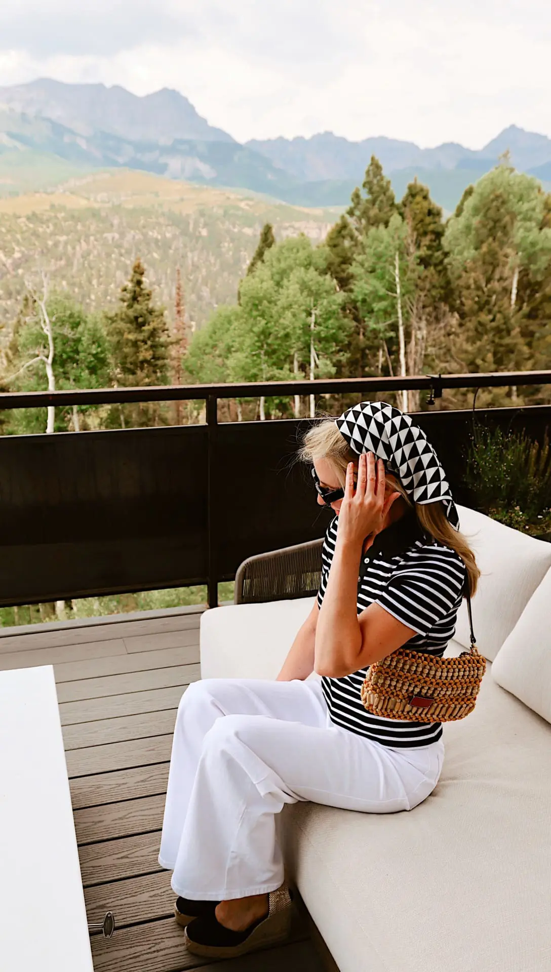 viral east coast summer style trend and how to wear it featuring striped polo shirt by Veronica Beard, white wide leg jeans by FRAME, prada triangle scarf in black and white and Staud beaded bag