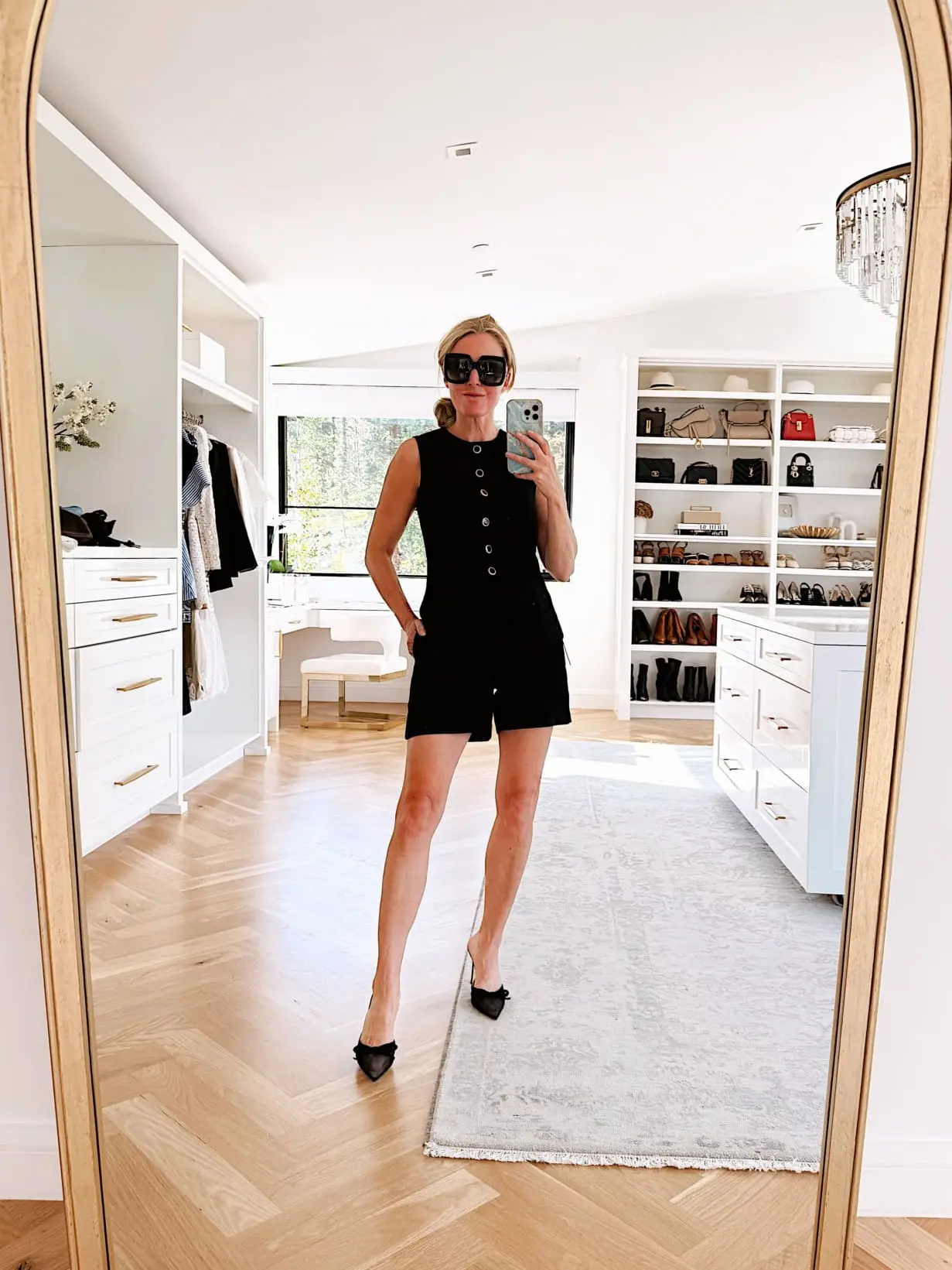 black shorts by Aritzia paired with black vest with gold buttons