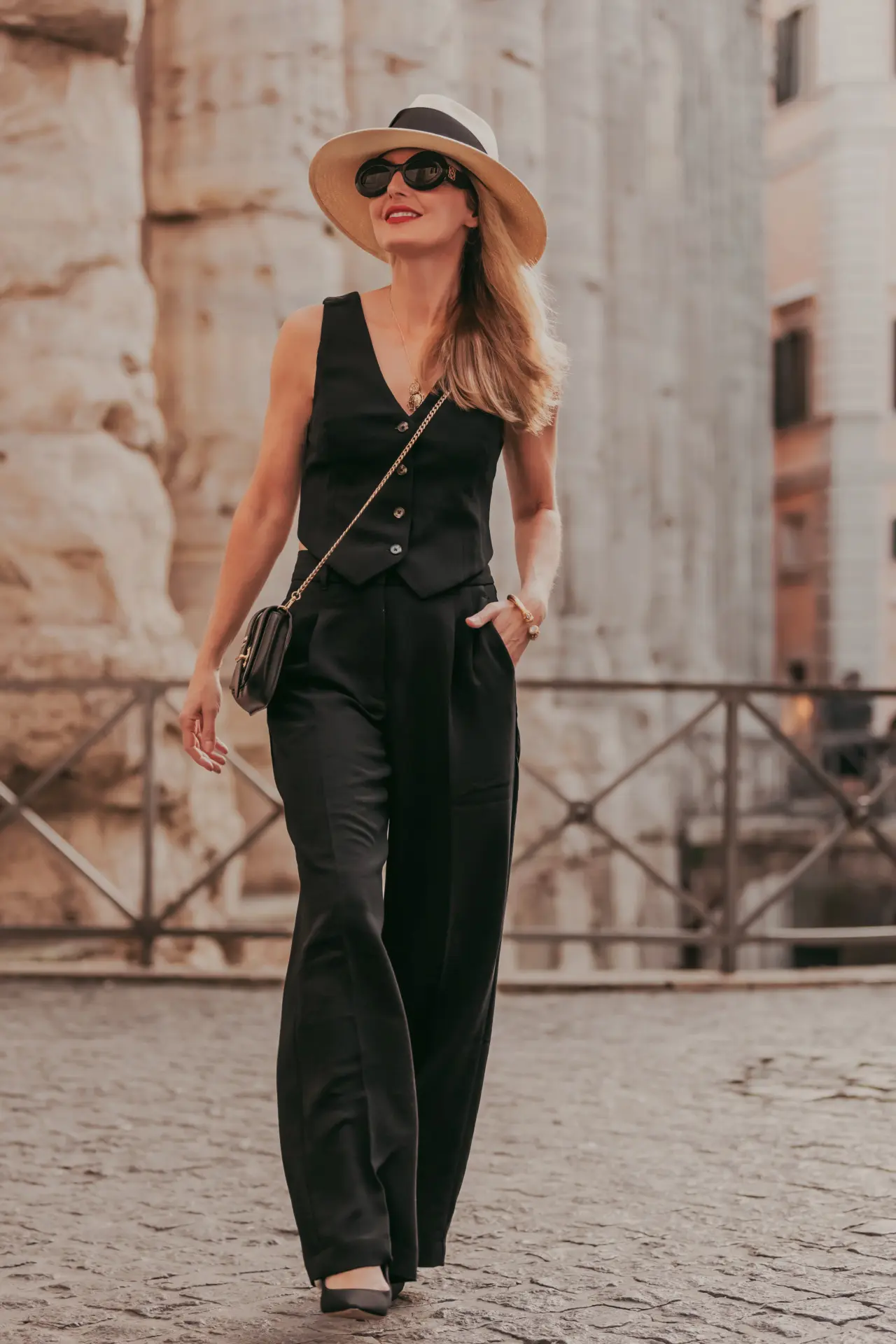 Aritzia black vest and black pleated trousers in Rome, Italy
