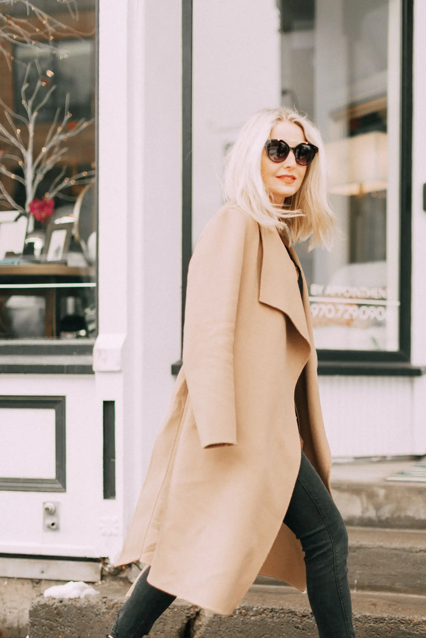 blond woman wearing black Vince Camuto Gerrty mules with black jeans and camel coat in telluride colorado