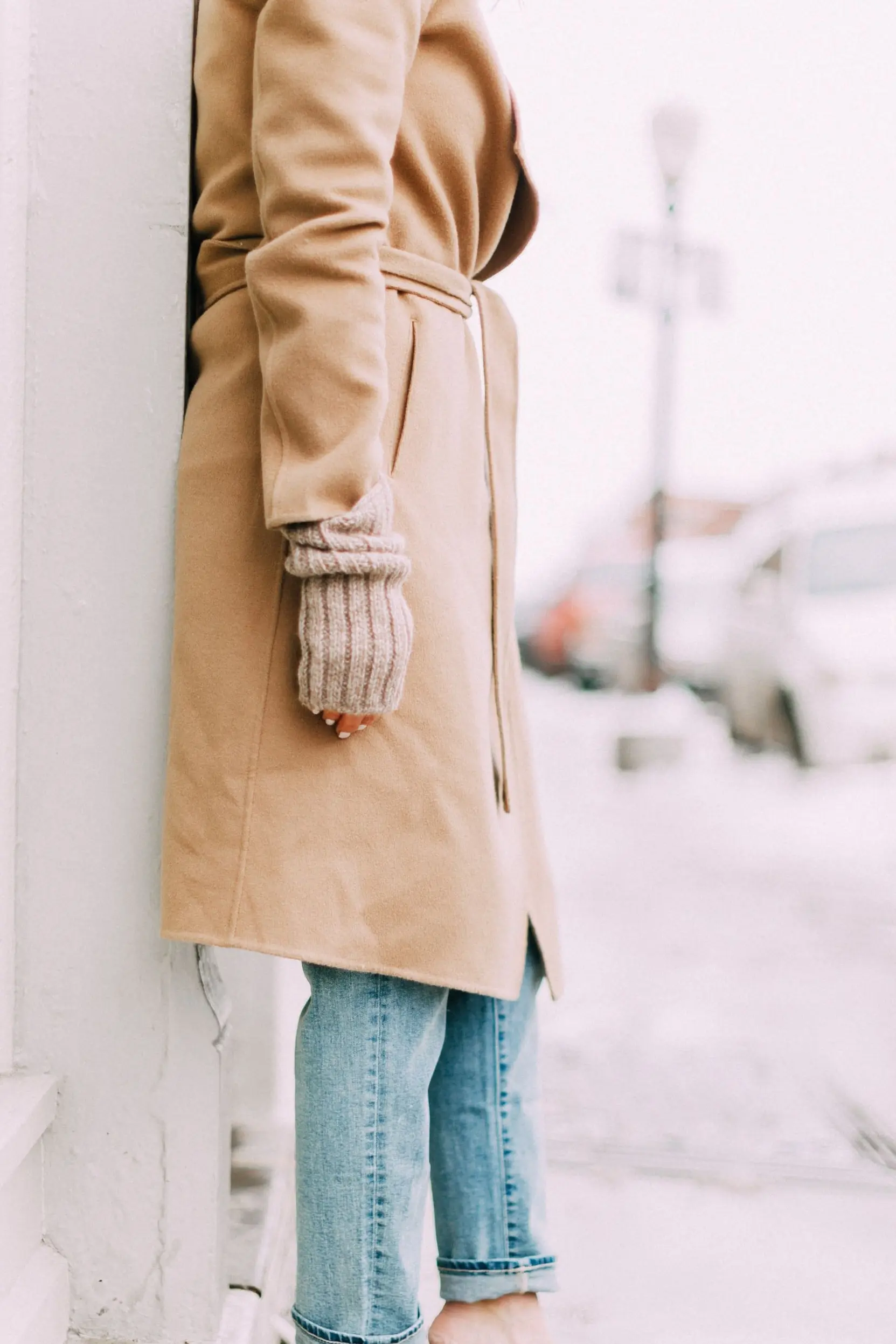 outfit with meghan markle inspired wrap camel coat blue jeans and snakeskin mules