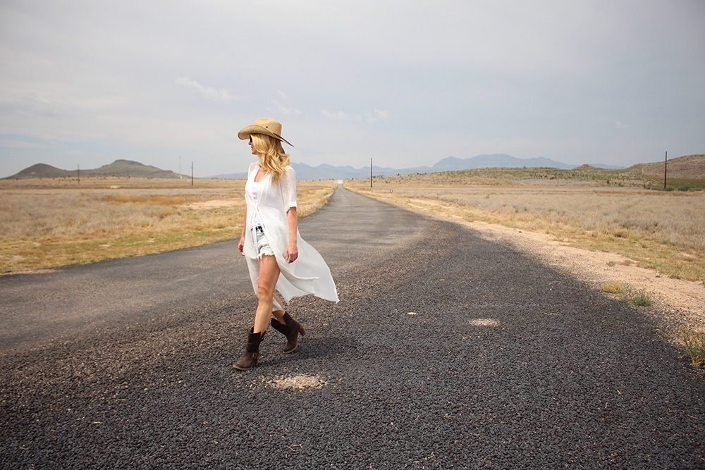 maxi shirt from Asos, denim cutoff shorts by BLANK NYC, cowboy hat and white tank with brown buckle moto boots