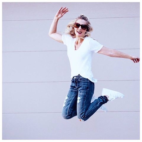 jump shot featuring vigoss distressed blue jeans, adidas white sneakers for women, and a free people white t-shirt