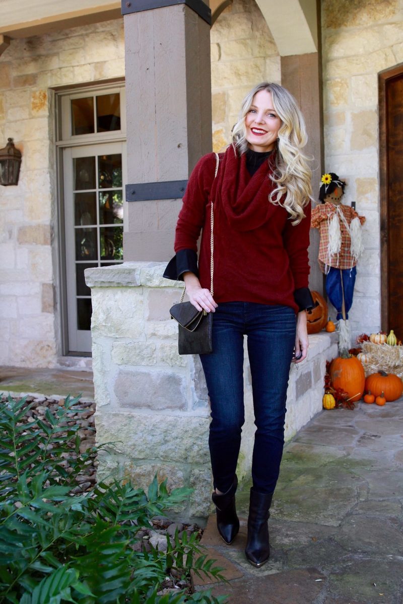 Layering a bell sleeve top under a cashmere burgundy sweater with dark wash skinny jeans and black ankle boots