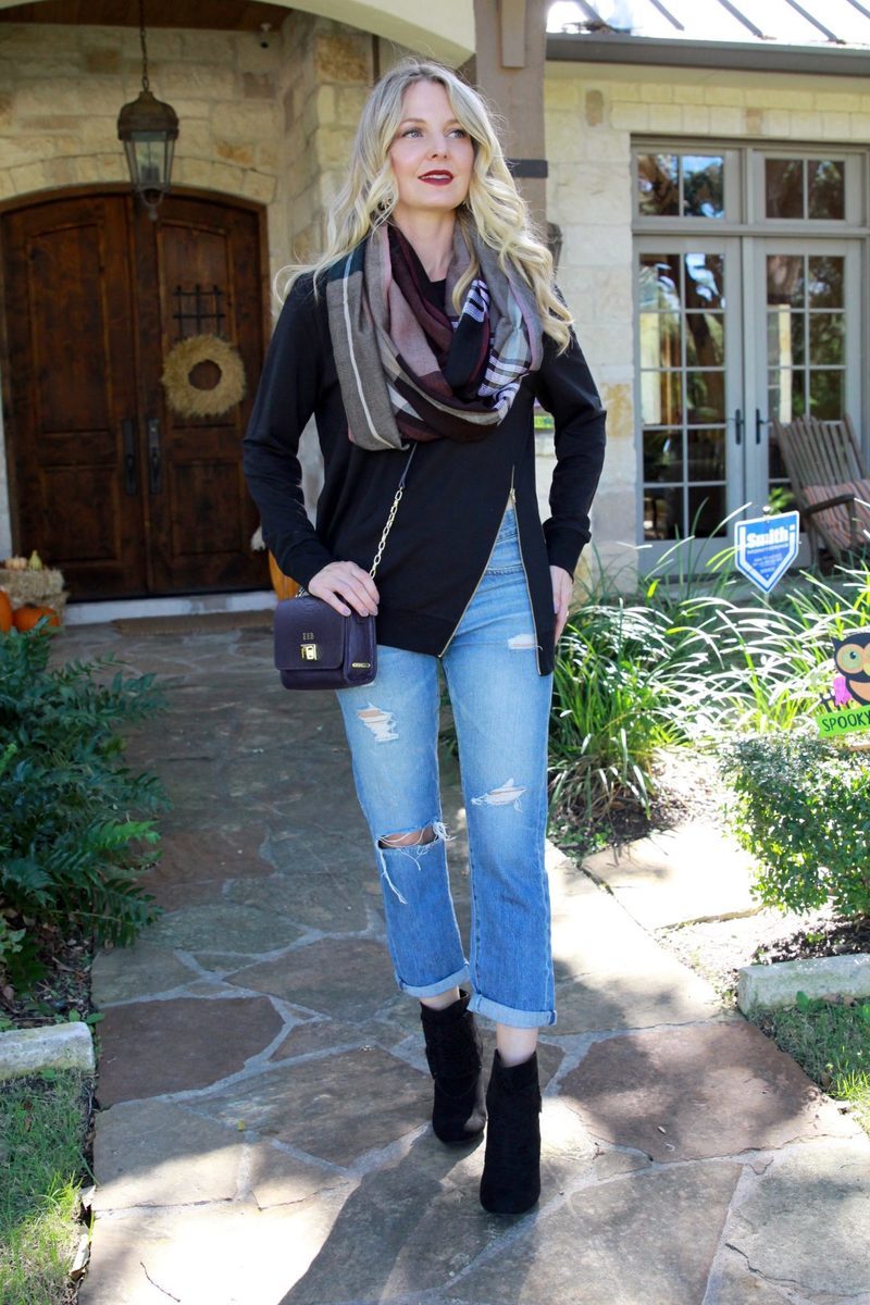 black booties with distressed boyfriend jeans by AG, paired with an edgy, black sweatshirt by C & C California and an infinity scarf