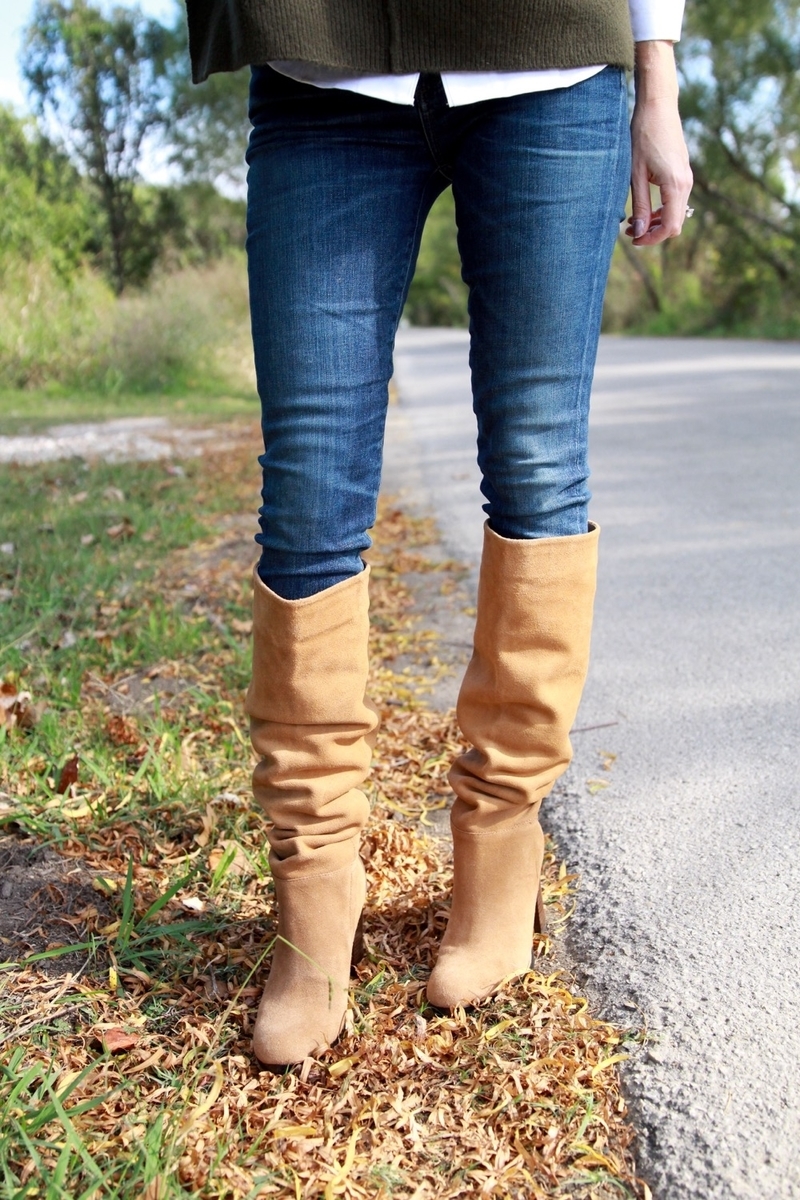 beautiful sam edelman camel suede boots scrunched over dark wash skinny jeans in fall leaves