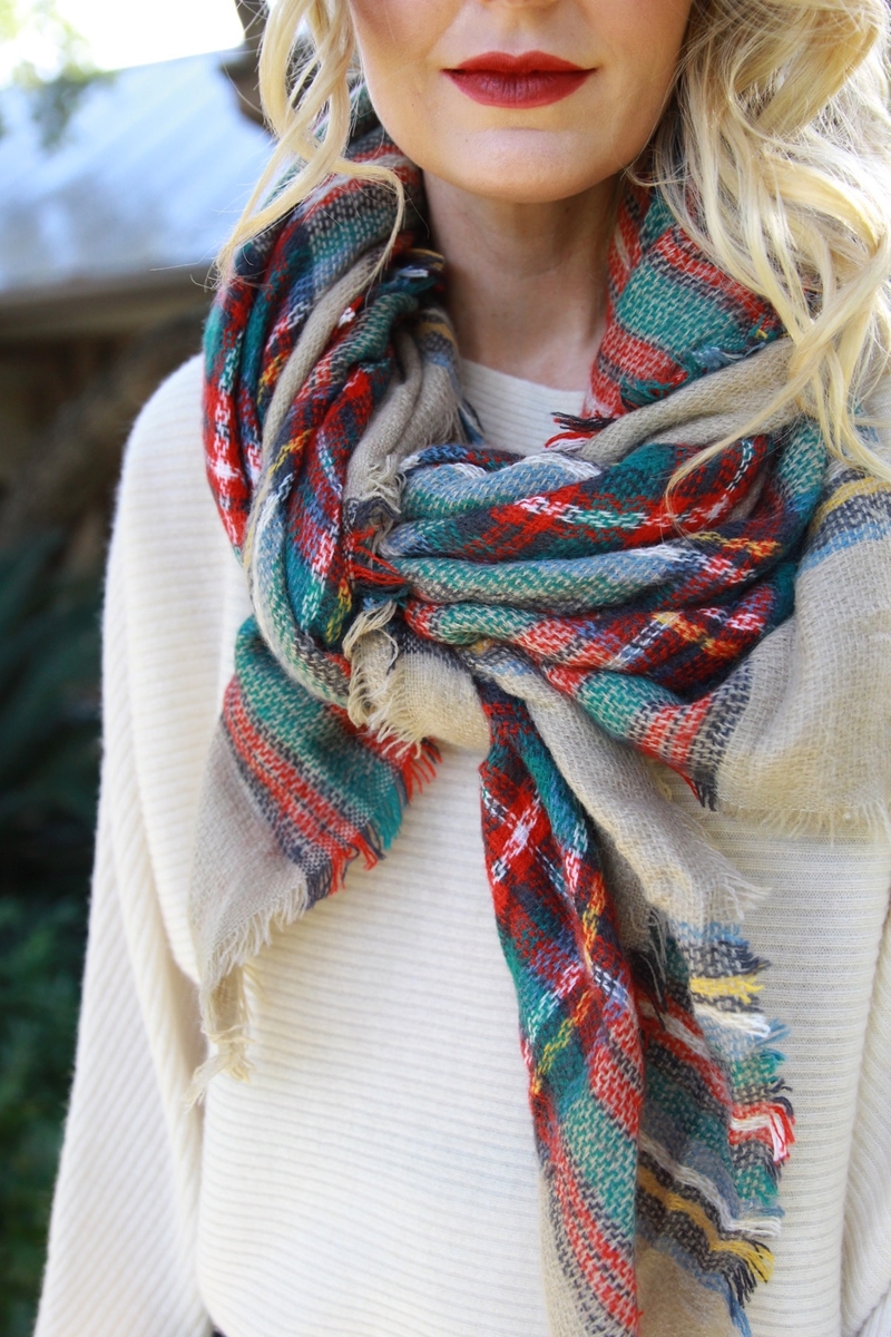 knotted blanket scarf in red and green with white cashmere sweater and red lipstick