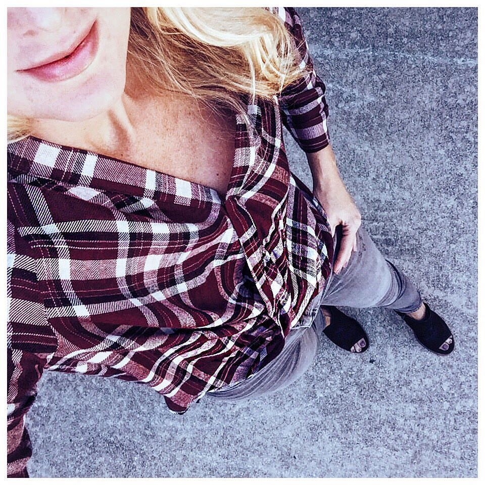 erin busbee wearing wrap front plaid shirt in burgundy with gray skinny jeans and black booties