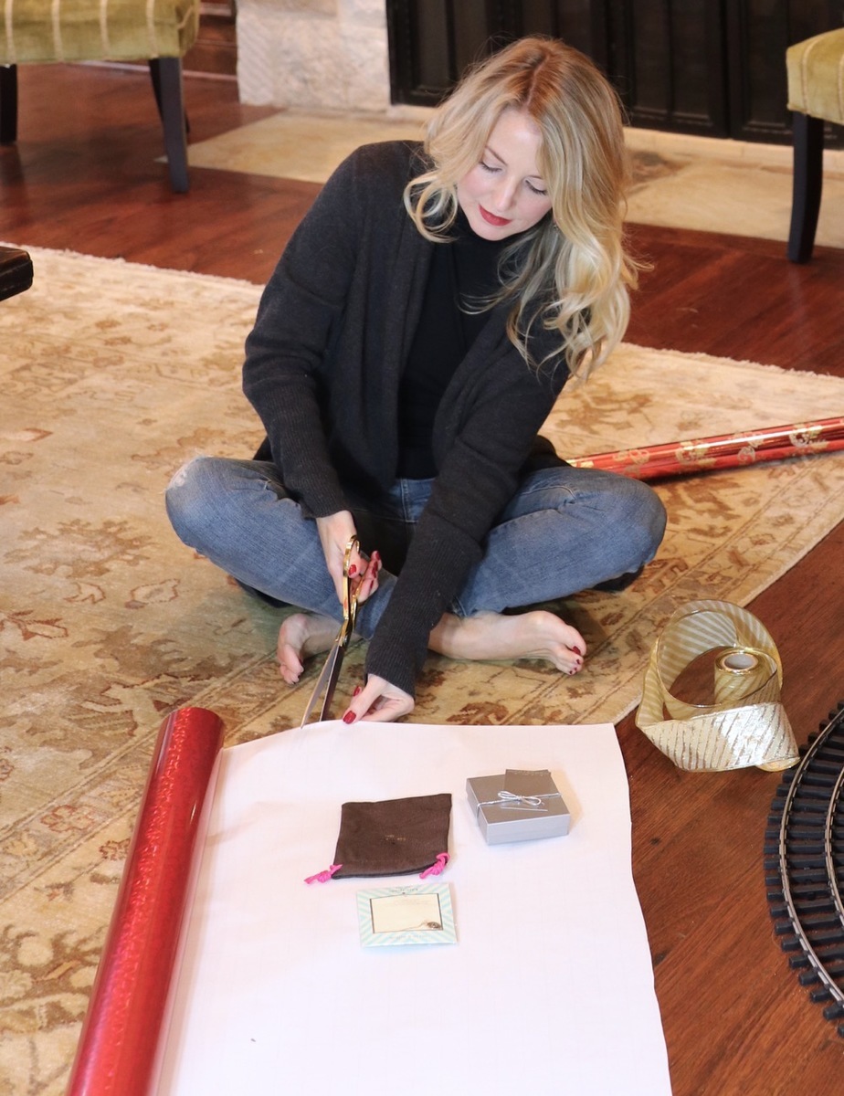 erin busbee wearing cozy cocoon cardigan by leith from nordstrom while wrapping presents by the christmas tree