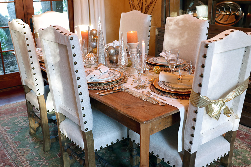 rustic chic decor holiday table setting featuring pottery barn table runner and napkins, silver and gold color theme and lots of ornaments 