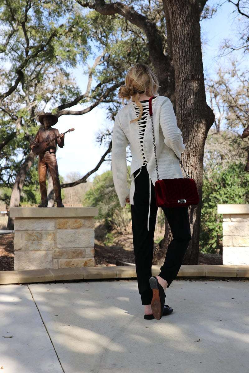 This laceup detailing on the back of the ivory ALC sweater gives it some interest and definitely a sporty touch. It's a subtle way to try the athleisure trend. This look is from neiman marcus