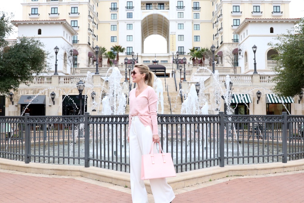 elegant and feminine outfit idea for work in the winter for the busy professional woman...this pink cashmere sweater paired with the wide leg, high waist white trousers will make you look longer and taller