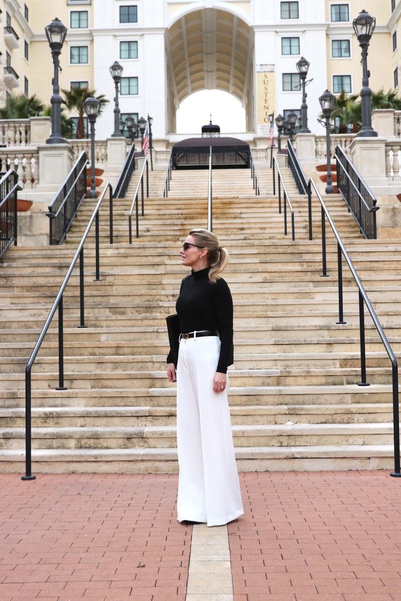 how to wear winter white, I show you three outfit options in this post including this look featuring a black classic turtleneck from nordstrom with a great black vegan affordable tote bag by sole society