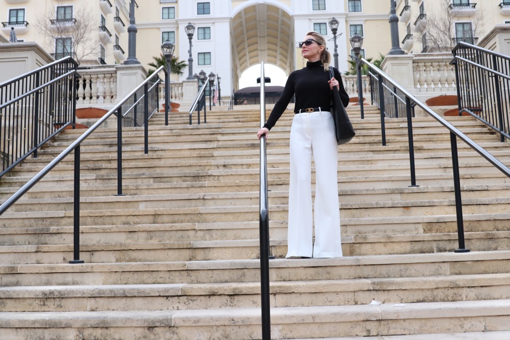 how to wear winter white, I show you three outfit options in this post including this look featuring a black classic turtleneck from nordstrom with a great black vegan affordable tote bag by sole society