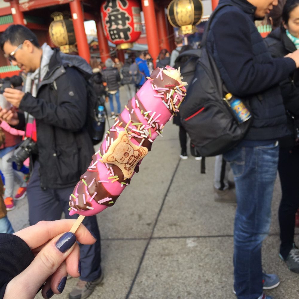the market near senso-ji temple i tokyo japan, shot of pink, candy-coated banana on a stick