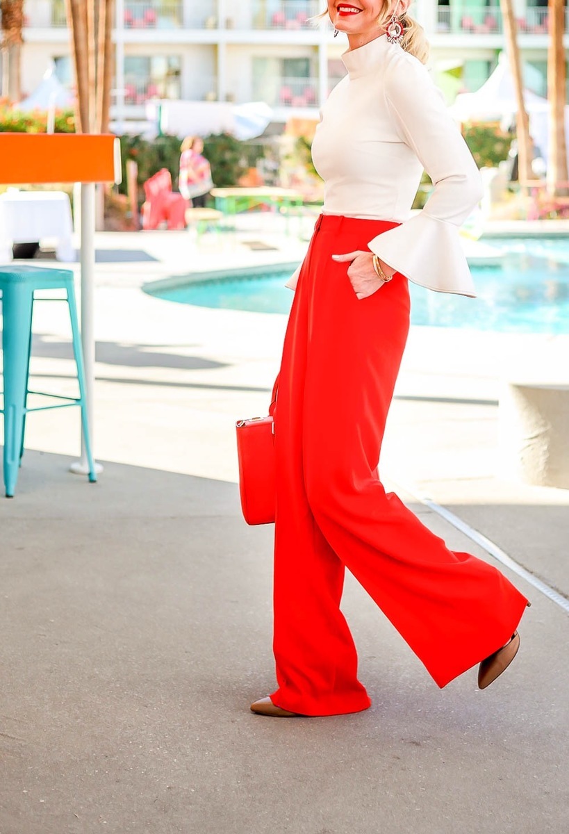 Bright pants are by BCBG. These high waist, wide leg trousers will make a big statement the matching red bag by Henri Bendel finishes off the look!