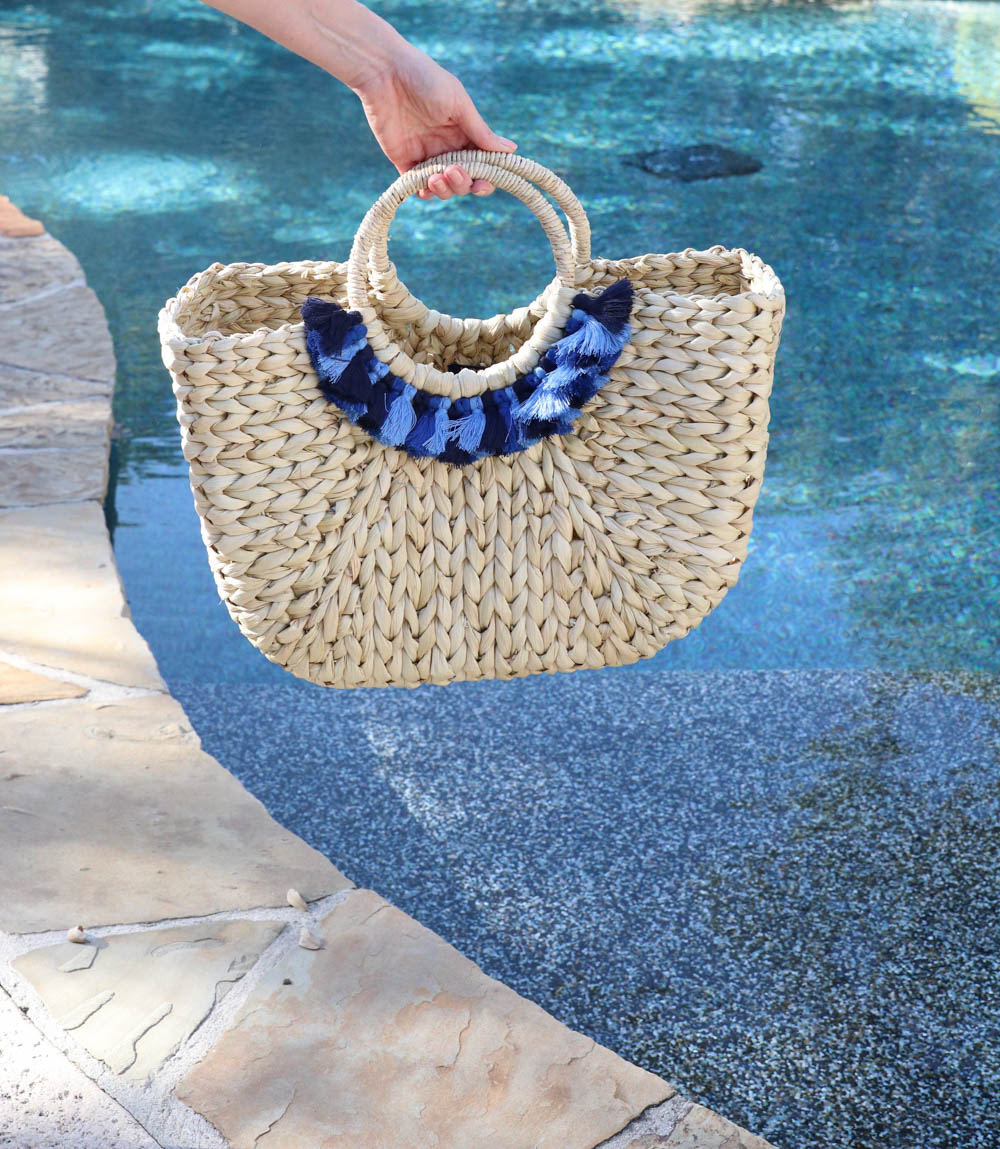 straw bag by the pool with cobalt and light blue tassels and pom poms