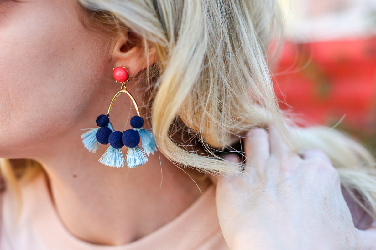 ruffles, these bright and colorful statement earrings by baublebar with bold blue pom poms go perfectly with the neutral blush and white tones