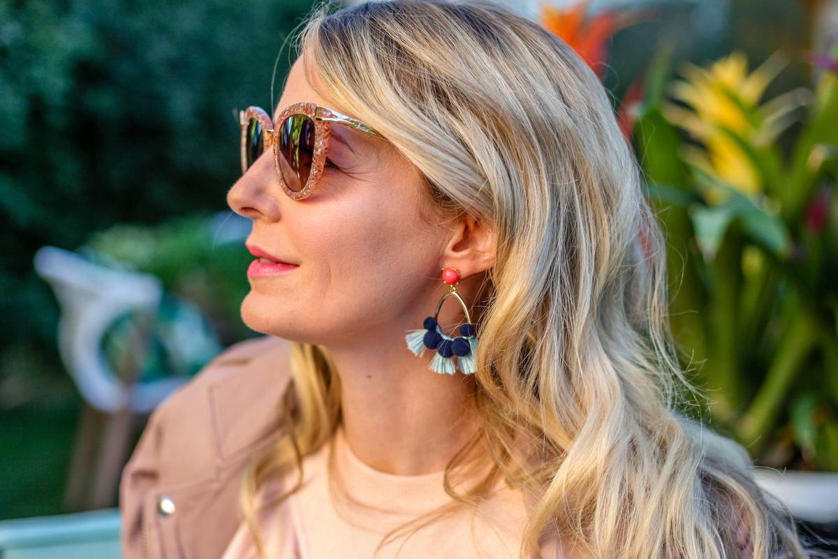 These statement earrings by baublebar with bold blue pom poms really pop against the peach tones in the moto jacket and sweater