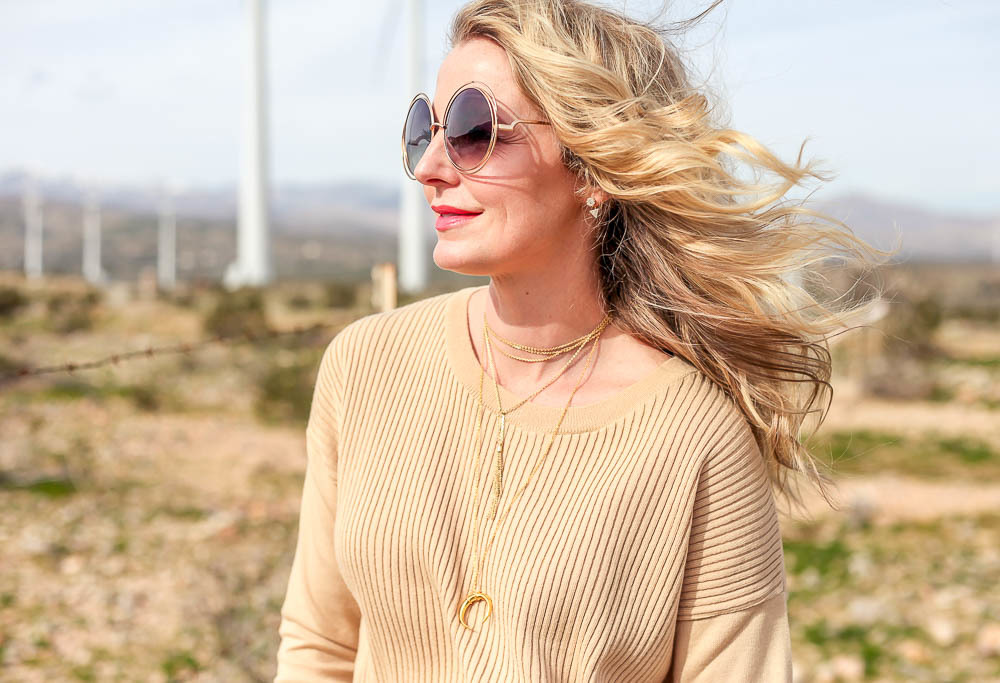 Fashion Blogger Erin Busbee over 40, wearing a matching ribbed sweater set in beige from Asos. Midi skirt with long sleeve sweater co-ords and python nude chunky heeled booties by Pour La Victoire, with chloe round sunglasses