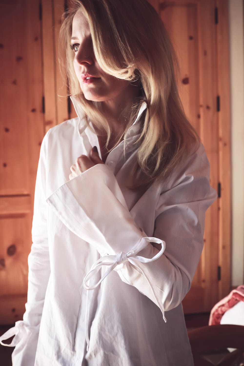 Laceup top by MLM in white button down poplin worn by Erin Busbee, fashion blogger and youtuber based in San Antonio, Texas. The laceup detail is a big fashion trend right now. Look for laceup pumps, flats, jeans, pants, tops, sweaters and jackets!