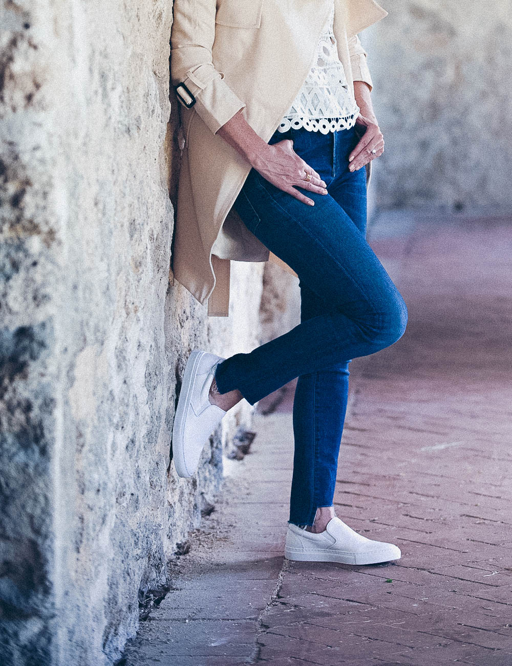 White sneakers slip on by Greats brand, worn 2 ways, including jeans and a one-shoulder top and a beige trench and white eyelet top, featured on Erin Busbee, of BusbeeStyle, fashion blogger and youtuber