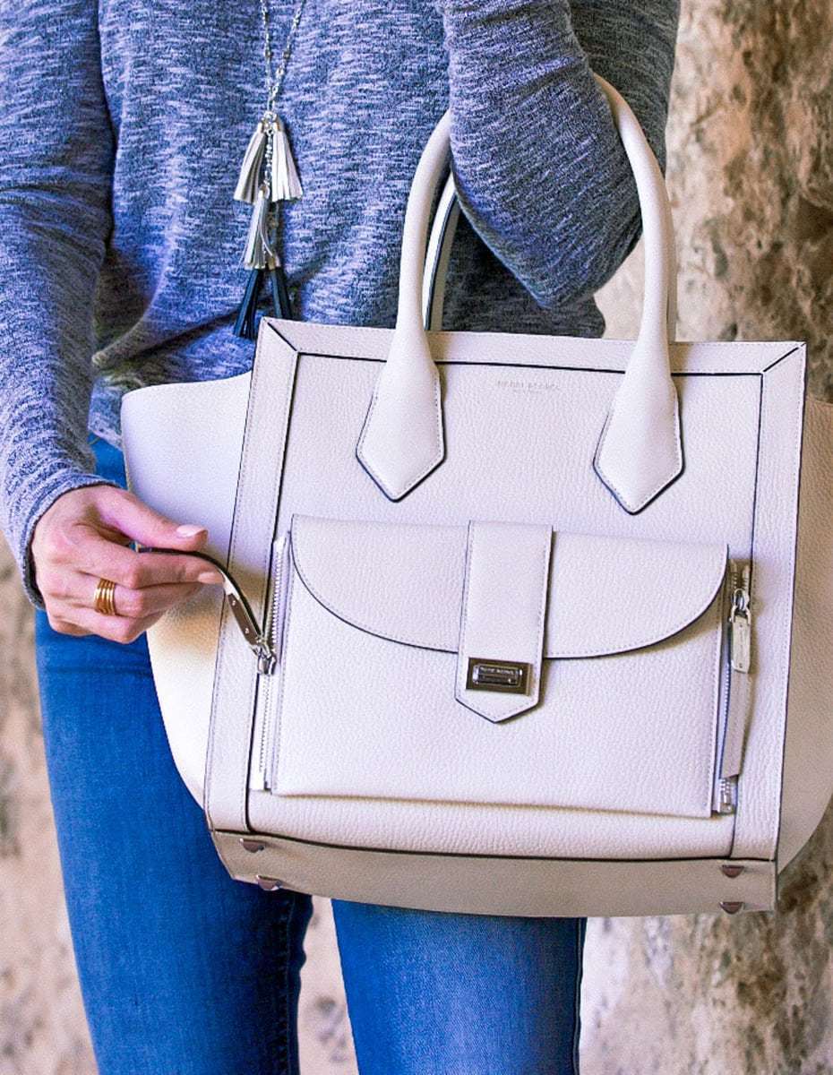 White bags are white hot for spring/summer! These trendy bags are neutral and versatile and will go with everything in your wardrobe. This post features white bags from Henri Bendel including the Rivington tote, a wallet and a mini crossbody white bag picked by fashion blogger and youtuber Erin Busbee of Busbee Style