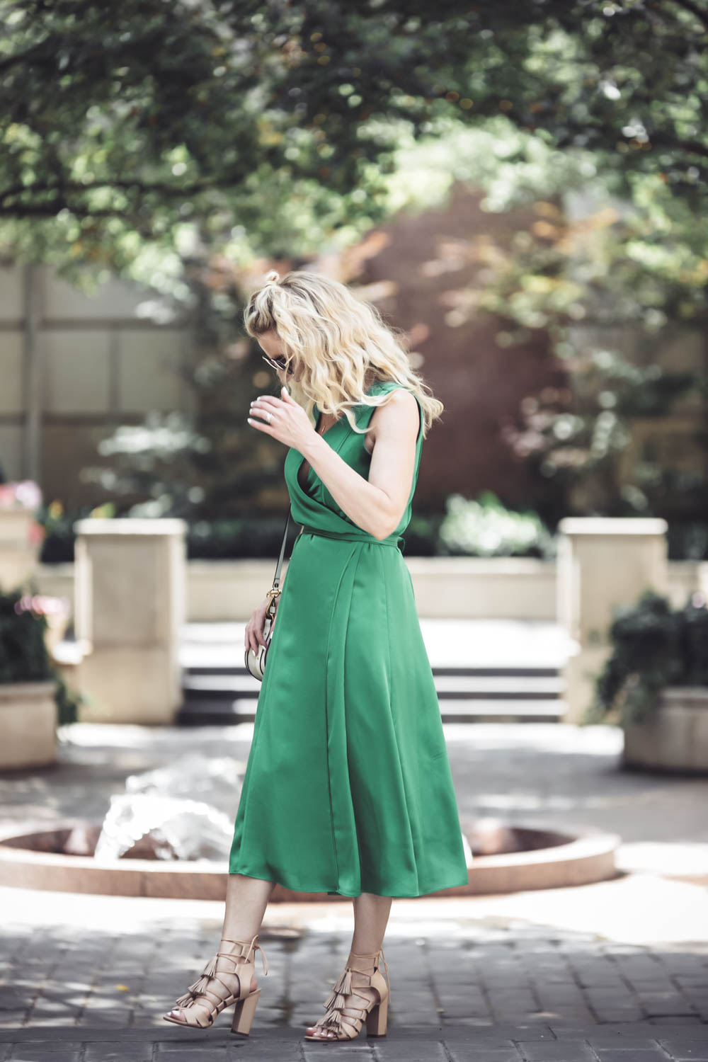 Reward Style Conference 2017 day two //Fashion blogger and fashion youtuber over 40, Erin Busbee of busbeestyle.com from san antonio texas wearing a silky green midi wrap dress from Banana Republic, with the Chloe nile bracelet bag in white, loeffler randall tassel sandals in nude and round sunglasses