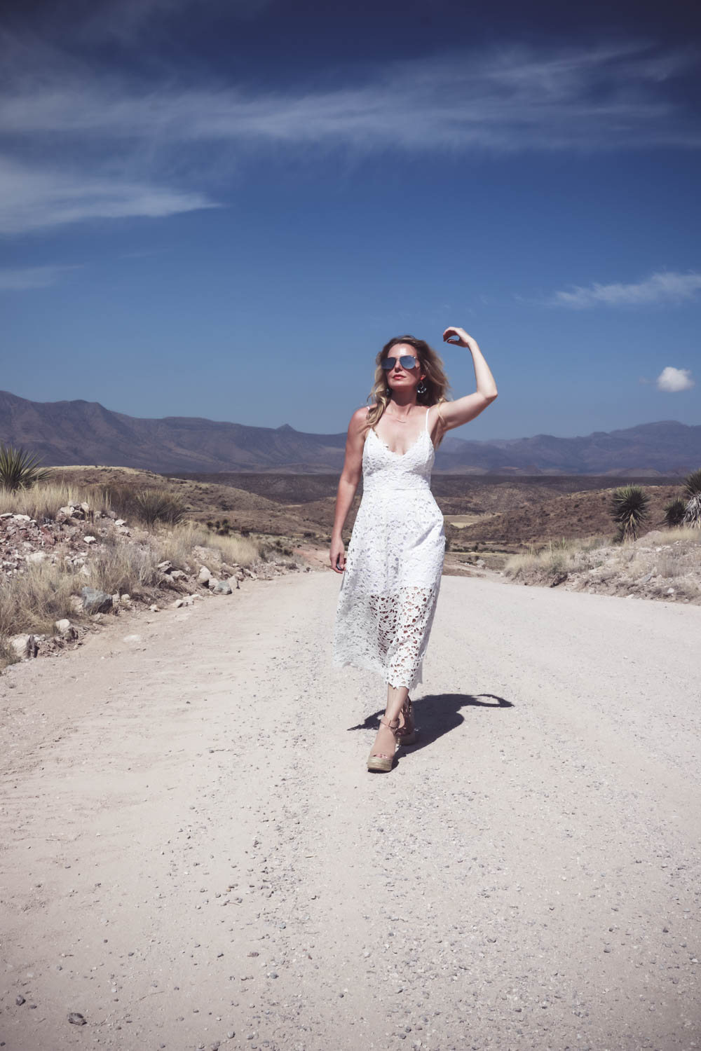 White lace dress on a desert dirt road in West Texas with Marc Fisher espadrilles in nude
