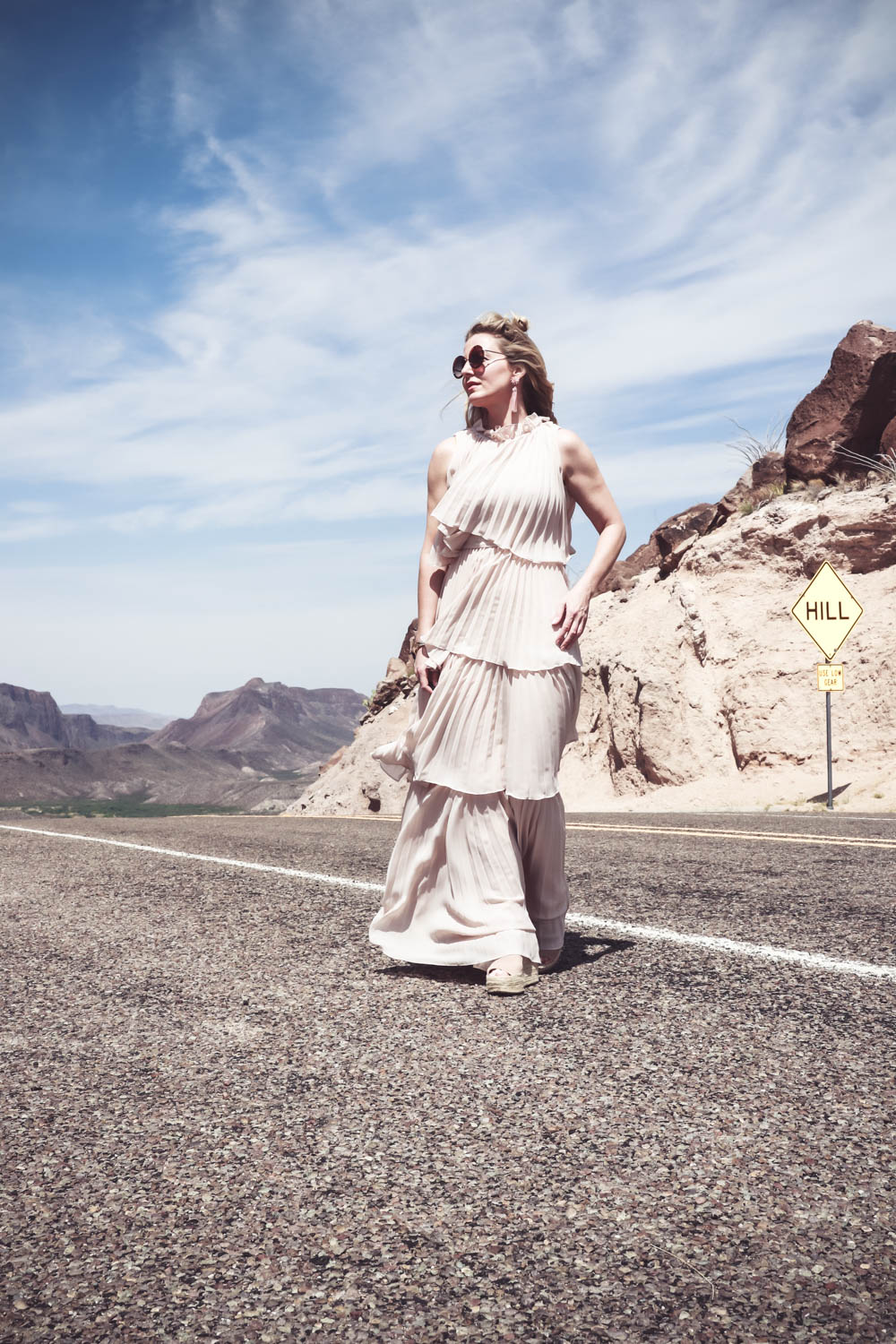 Ruffle gown on the Rio Grande river, fashion blogger and fashion youtuber over 40, Erin Busbee shows us one way to wear a statement dress in nude color // make a huge statement at a wedding or special event