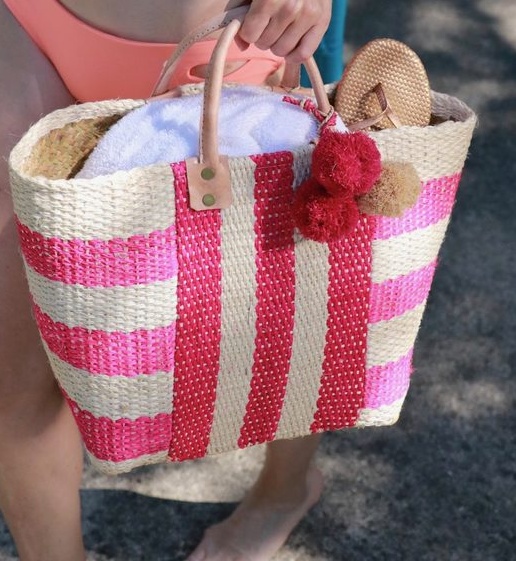Bikini over 40? Why not! Erin Busbee of Busbeestyle shows us a few options that offer more coverage for mature women who want to wear bikinis over 40 - wearing Becca peach bikini here, poolside, swimwear for mature women. and pink straw beach bag from Nordstrom