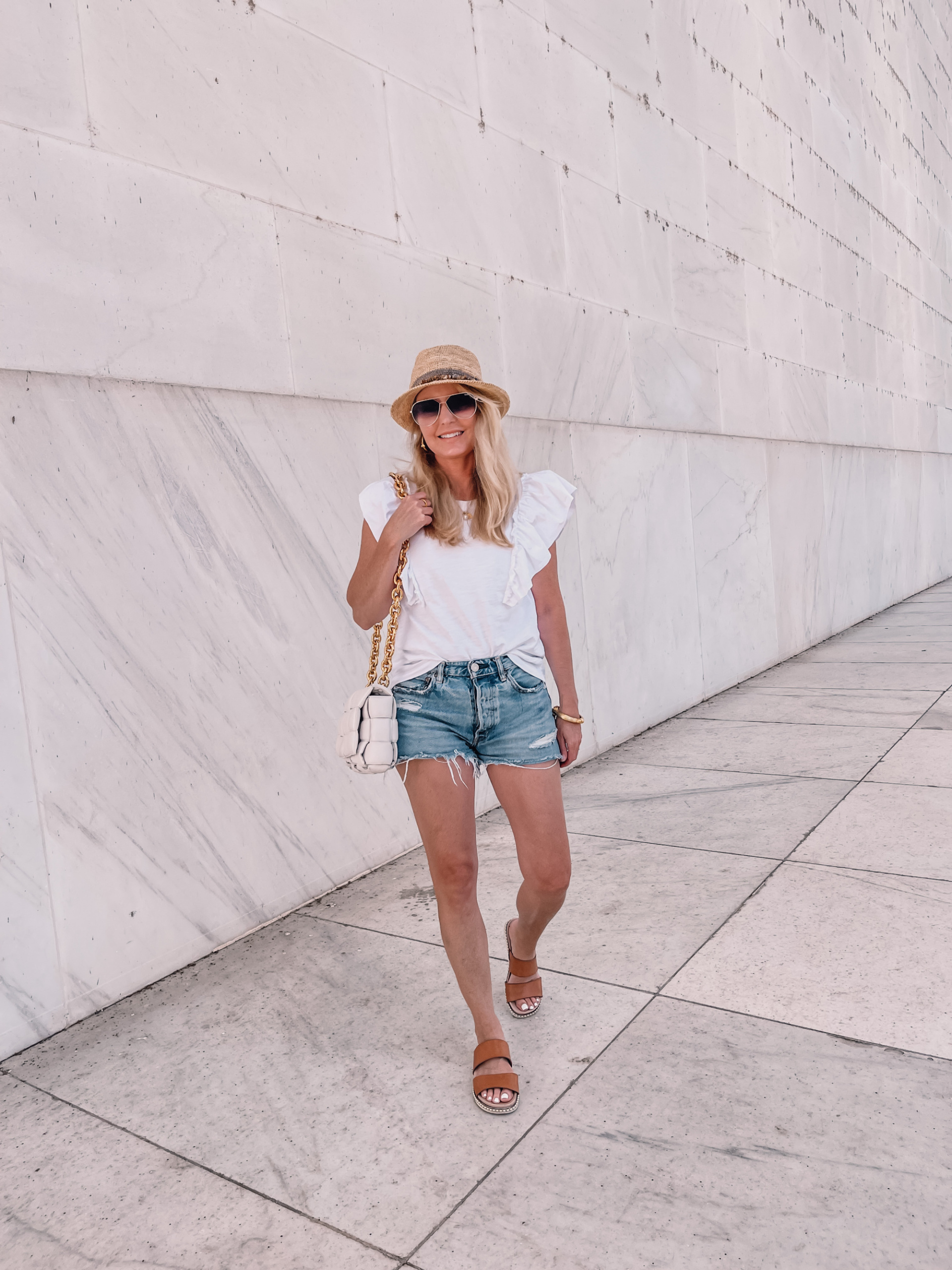 outfits for long road trip featuring Moussy jean shorts and white ruffle shoulder tee by Nation LTD on fashion over 40 blogger Erin Busbee in Washington, DC
