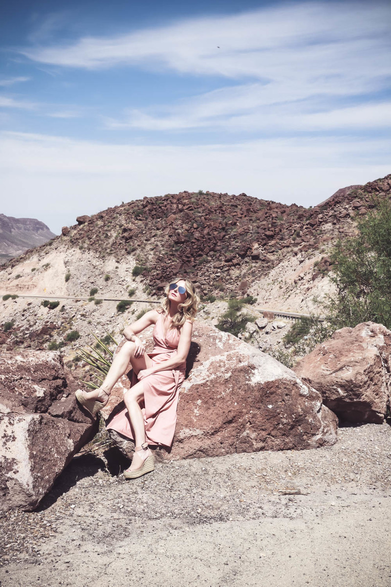 Wrap Dress by Wyldr from Asos and Revolve in blush nude color with Marc Fisher perforated ankle strap espadrilles wedges, on fashion blogger and fashion youtuber erin busbee of busbestyle, san antonio, texas, shot near Big Bend National Park in West Texas along the Rio Grande 