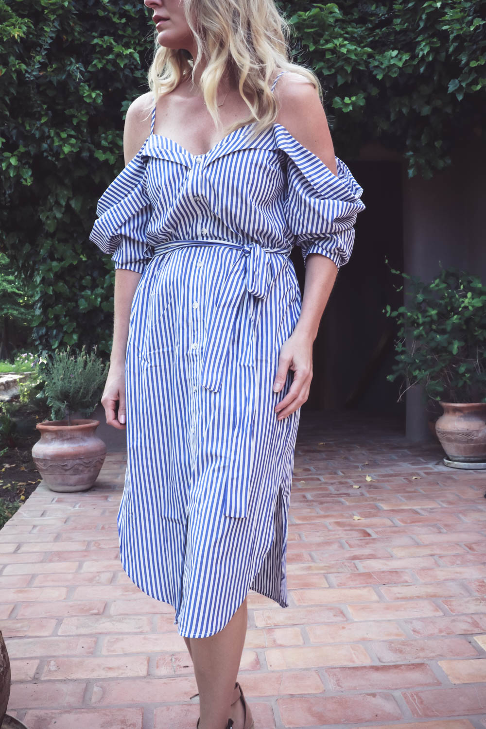 cold shoulder trend, exposed shoulder shirt dress by Bardot in blue and white stripes, paired with marc fisher wedges, quay mirrored sunglasses on fashion blogger and youtuber over 40, erin busbee