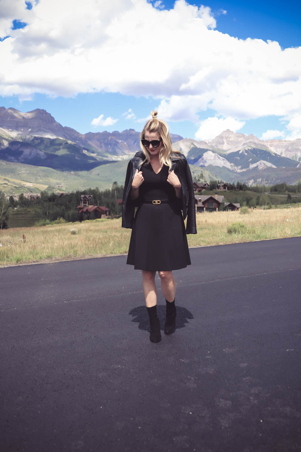 Wear Now, Wear Later, little black dress fit and flare by Eliza J, styled with black ankle booties, a black leather moto jacket, and a salvatore ferragamo belt