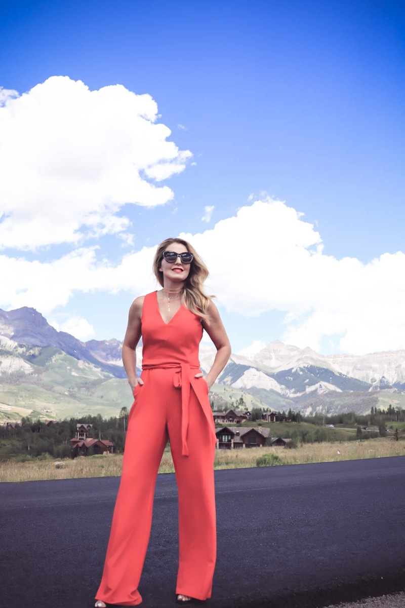 Look great in pictures, how to tips and tricks so you look amazing in pictures! By Fashion blogger Erin Busbee of Busbee Style from Telluride Colorado, hands in pockets pose with red vince camuto jumpsuit
