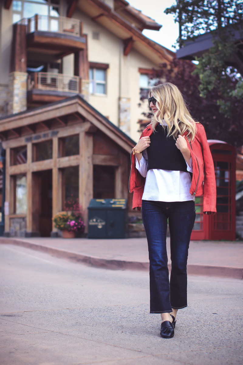Red moto jacket by Doma, layered over a black free people sweater vest, halogen white ruffle neck blouse and cropped dark wash kickflare rag & bone jeans with sam edelman paris tassel loafers and giles & brother gold bracelets on colorado fashion blogger Erin Busbee of Busbee Style, Fashion over 40