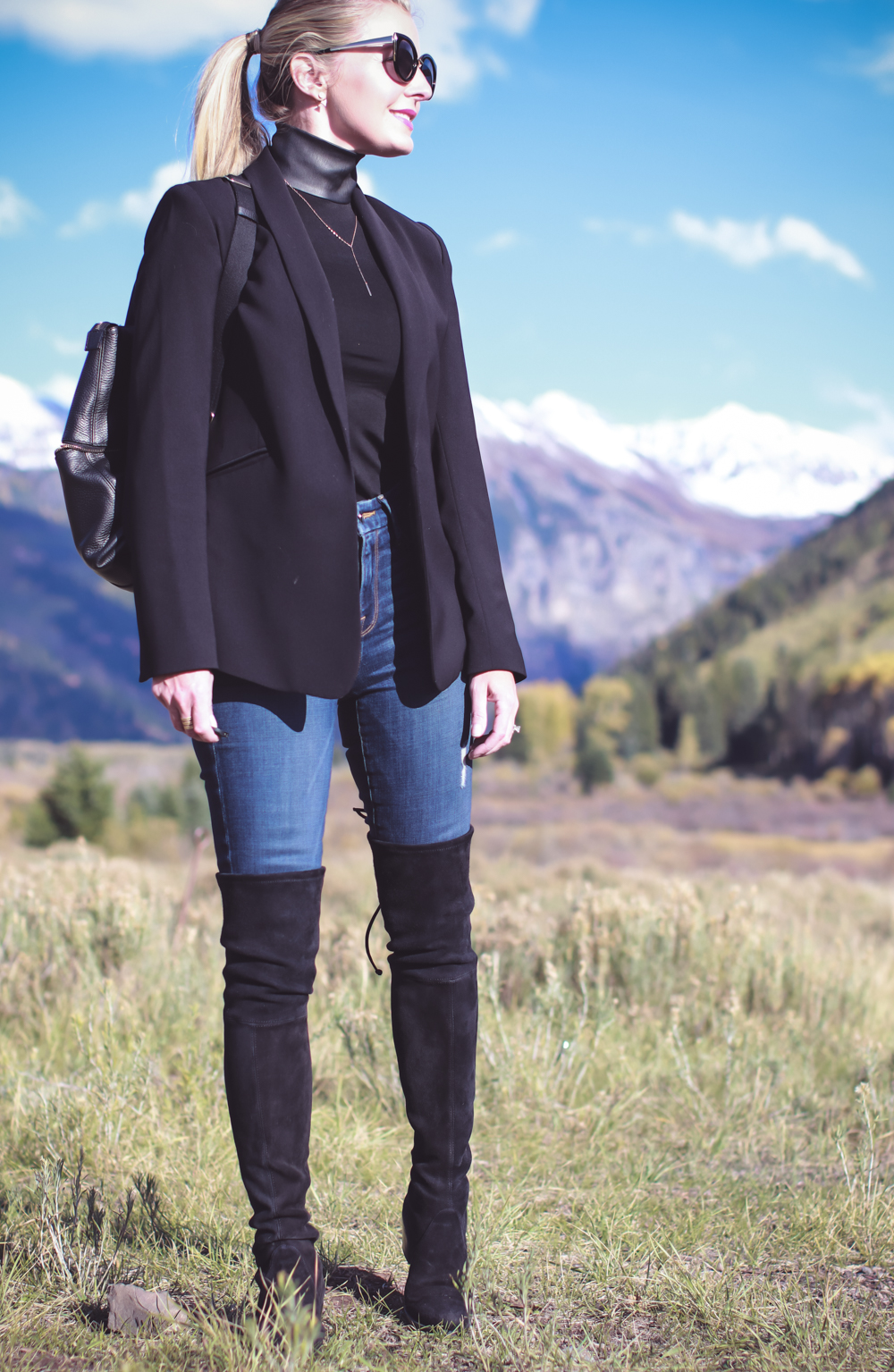 Tall Boots, over the knee boots, how to wear otk boots if you are tall or petite, featuring fashion blogger, Erin Busbee of Busbee Style in Telluride, Colorado, wearing Stuart Weitzman lowland boots , carrying Henri Bendel Jetsetter convertible backpack, with vince camuto blazer and barney black turtleneck