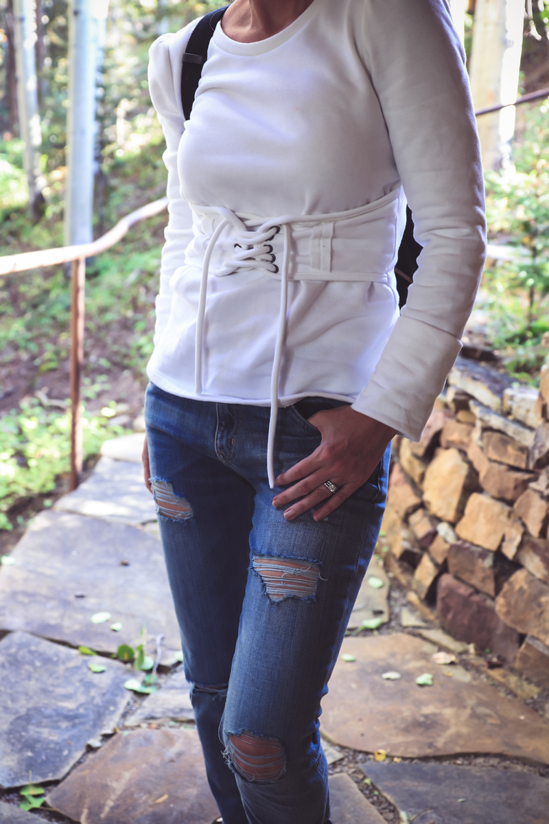 Boyfriend jeans by Current & Elliott, paired with a corset waist sweatshirt from nordstrom and Greats sneakers called royale, on fashion blogger from colorado, Erin Busbee of busbeestyle