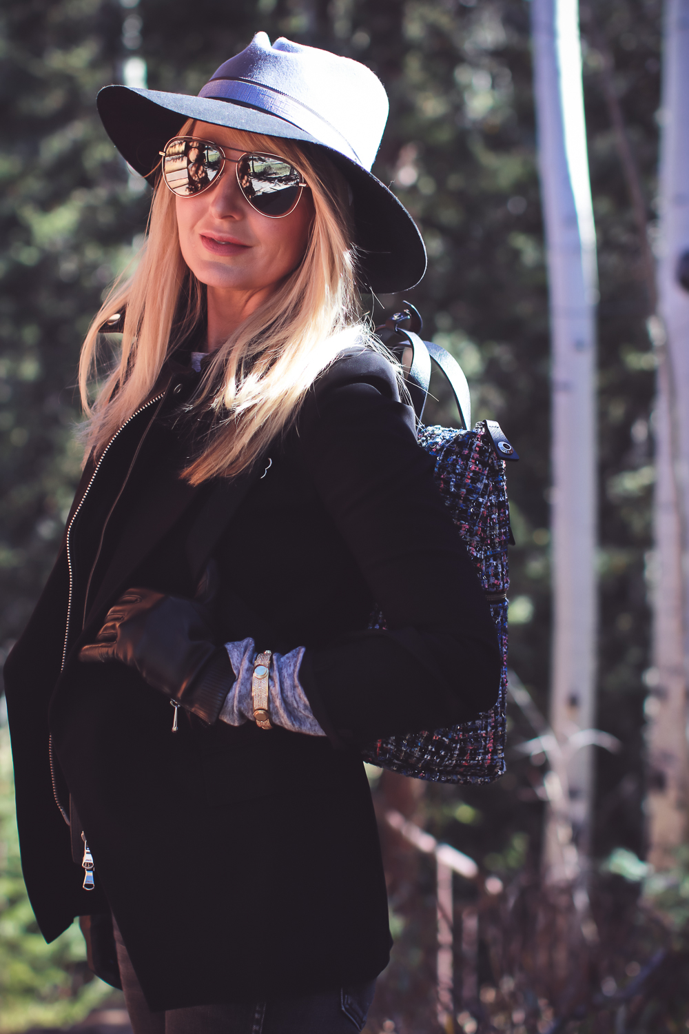 Styling Hats for women for fall and winter, featuring a Henri Bendel felt hat, paired with a jetsetter tweed backpack, veronica beard blazer with leather dickey and amo twist jeans with vince camuto patent booties on fashion blogger over 4o from Busbee Style Erin Busbee