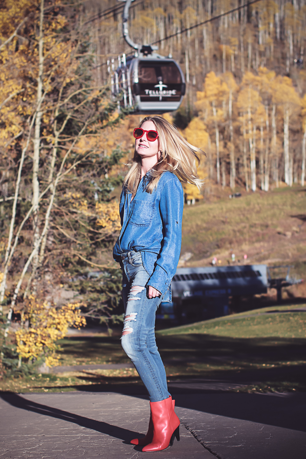 How to wear red boots, red booties by Dolce Vita with denim on denim look, on fashion blogger over 40, Erin Busbee of Busbee Style in Mountain Village, Colorado