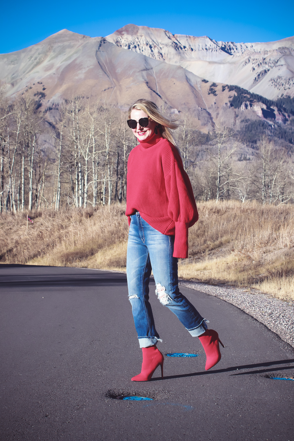 Sock Booties, what are they, how to style sock booties, featuring these red Steve Madden sock booties, Mother dazzler jeans, and a red oversized topshop turtleneck sweater on fashion blogger over 40, Erin Busbee of Busbee Style in Telluride Colorado