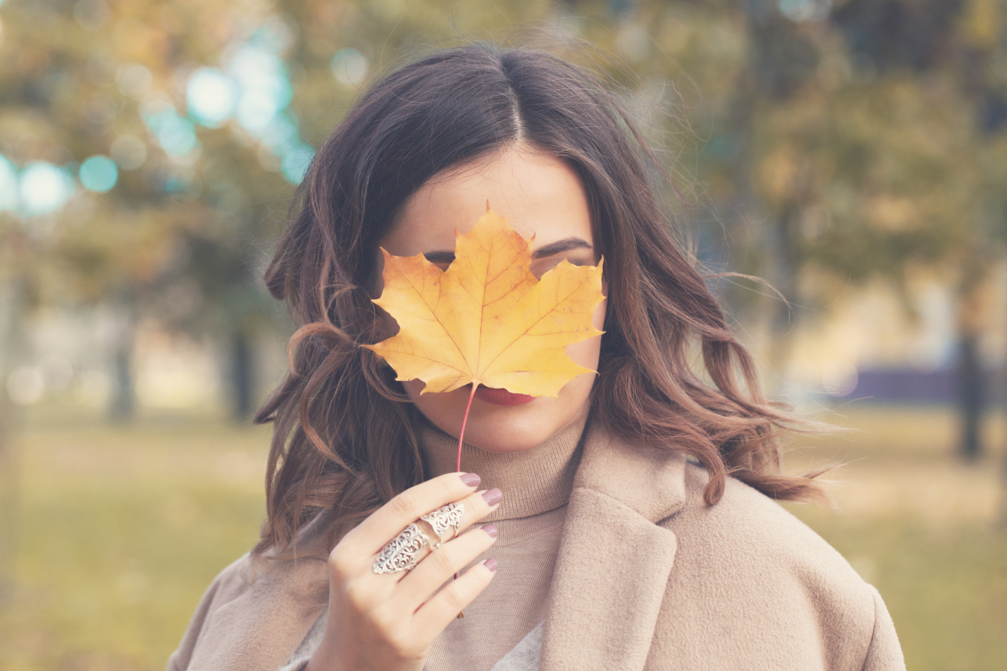 fall makeup, three ways update fall makeup routine, beauty 40+ woman, dark haired women with a leaf covering her face