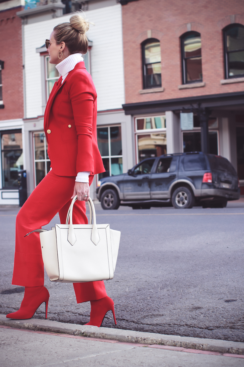 How to wear red from head to toe featuring fashion blogger over 40, Erin Busbee of Busbee Style in Telluride, Colorado wearing a Smythe suit and Steven Madden sock booties
