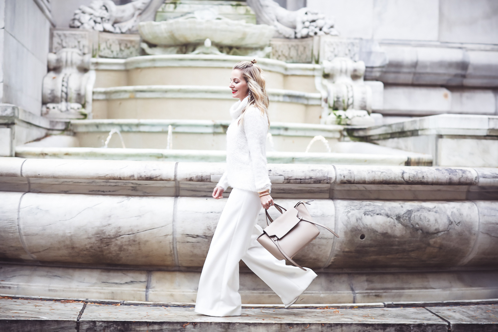How to wear all white and still look slim, winter white, Fashion blogger Erin Busbee of Busbee Style in NYC wearing white wide leg trousers by Milly and a fuzzy white sweater with Celine belt bag and who what wear white target mules